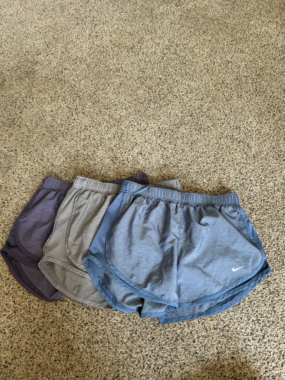 Nike women's running shorts set in blue, gray, and purple